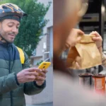 Ciclista entregador com mochila térmica amarela consultando o celular na rua, ao lado de cliente retirando sacola kraft e café no balcão de restaurante