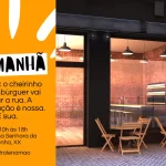 Convite visual para inauguração de hamburgueria com fachada moderna em tijolos e mobiliário externo; destaque para a frase “É Amanhã” e endereço do evento.